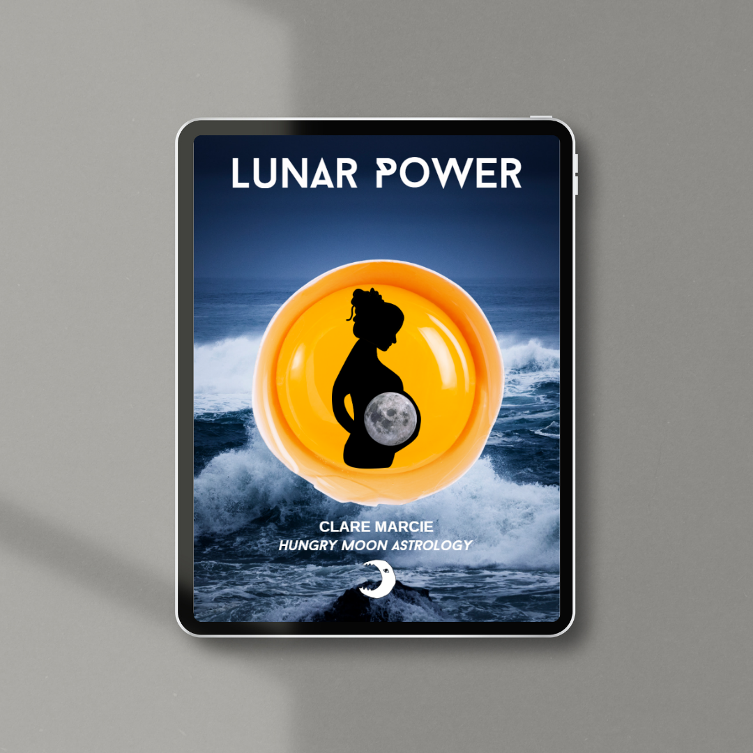 The screen of a computer tablet features a title page with the title 'Lunar Power' above an ocean, atop which is the centre of a yolk in a shell. Inside this is a silhouette of a pregnant woman side on with a moon in her belly. Below it, text reads: Clare Marcie, Hungry Moon astrology. Below that is the logo for Hungry Moon astrology of a moon with an eye and teeth